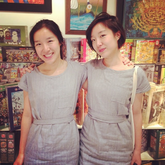 asian twins wearing matching dresses
