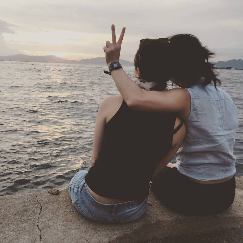 twins sitting on dock